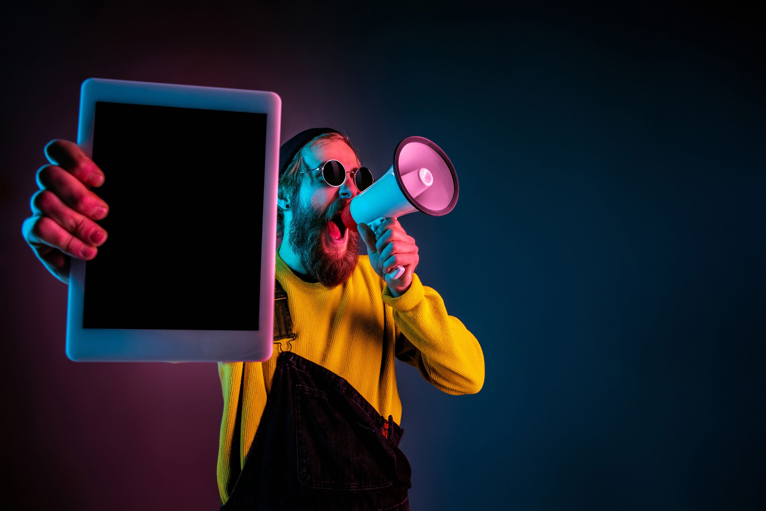 Caucasian man’s portrait isolated on gradient studio background in neon light
